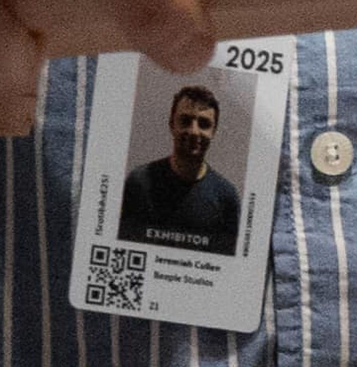 Actual event badge showing the portrait, EXHIBITOR designation, Jeremiah Cullen name and Beeple Studios affiliation